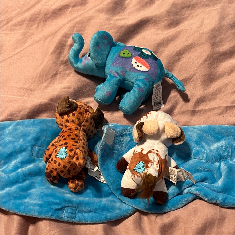 Mini stuffed animals, one elephant, one cow and one puppy